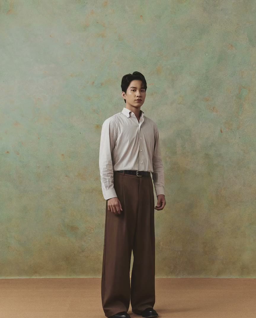 Second Sons lookbook: a model on a green painted backdrop